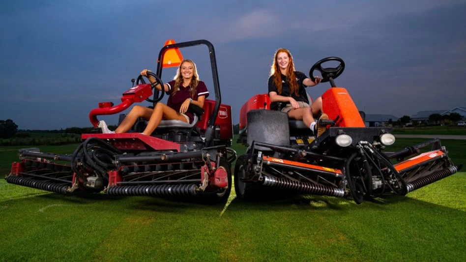 Megan Muesse (left) and Hailey Tucker were part of the 16-woman grounds crew at the Little League Softball World Series in North Carolina. 