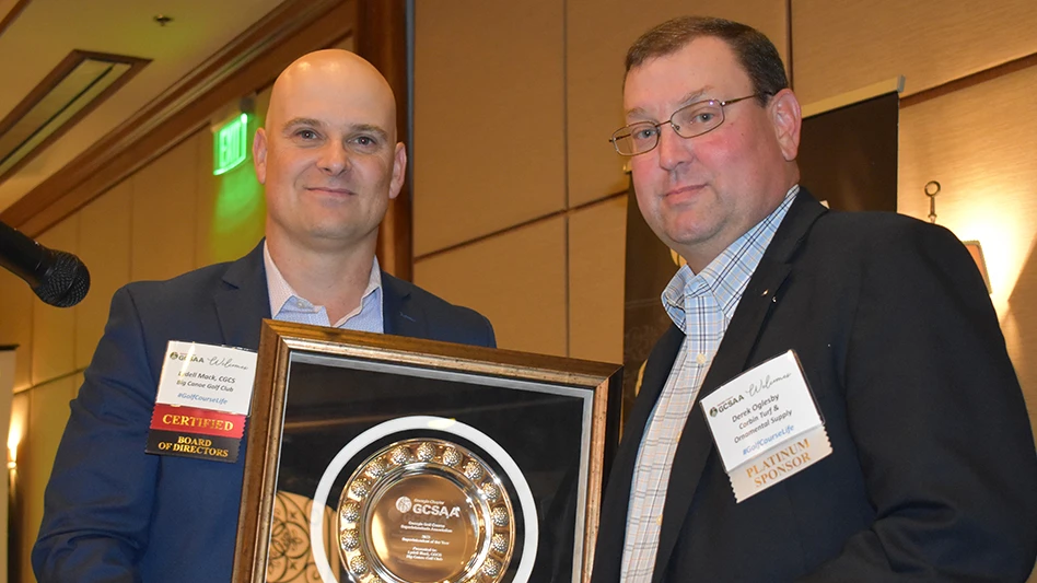 Big Canoe Golf Club's Lydell Mack (left) accepts his Georgia GCSA Superintendent of the Year award from Corbin Turf & Ornamental Supply's Derek Oglesby.
