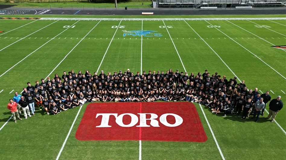 Brentsville District High School students stand around a Toro logo.