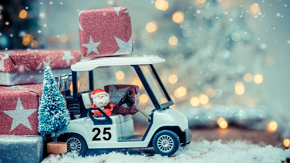 A Santa Claus toy in a toy golf car.