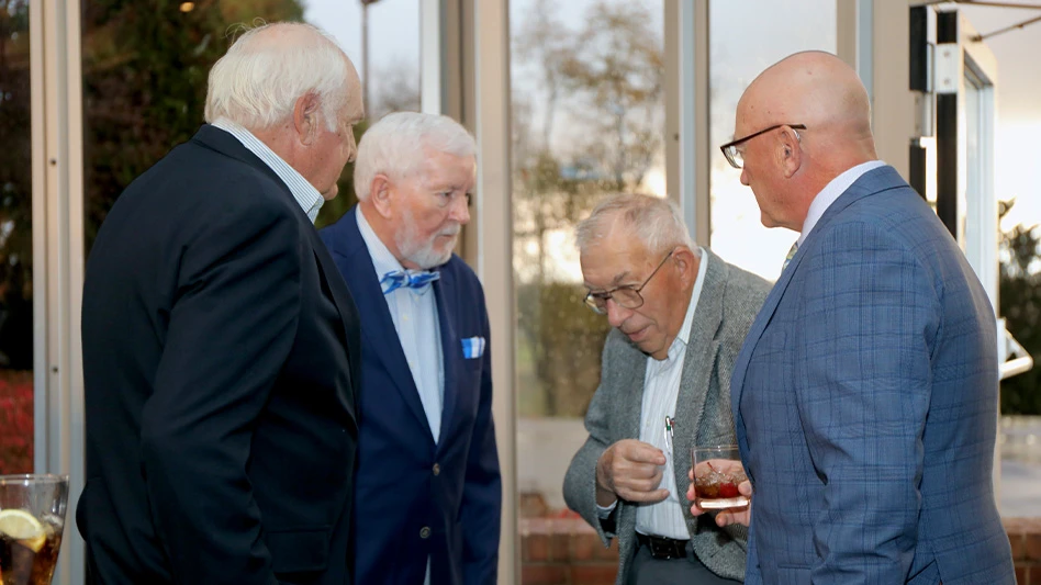 A group talks at the PAGCS centennial celebration.