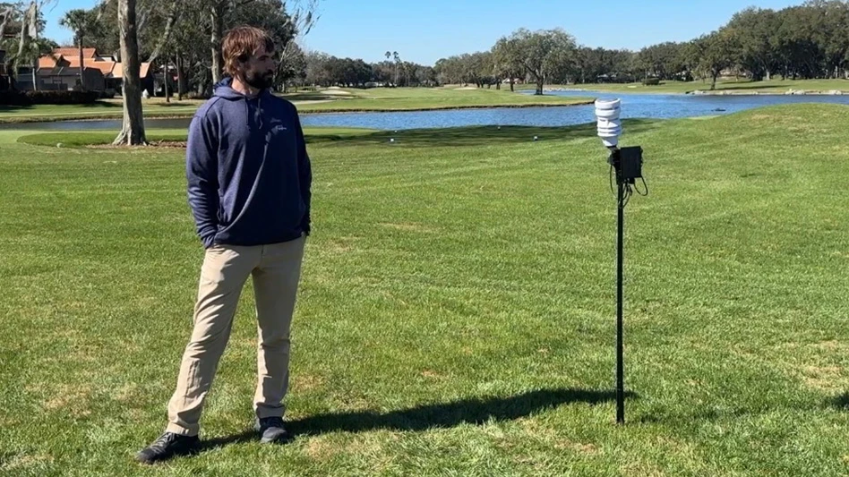 Dr. Travis Roberson, Syngenta Digital Platforms technical field manager, stands next to the new Aero GCX microclimate sensor.