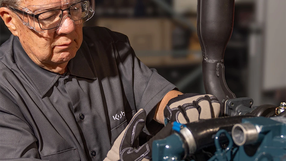 An equipment technican works on a motor.