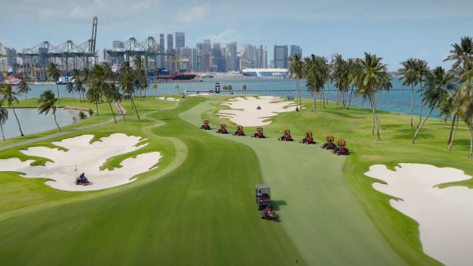 A string of mowers tend to a fairway at Sentosa Golf Club in Singapore.